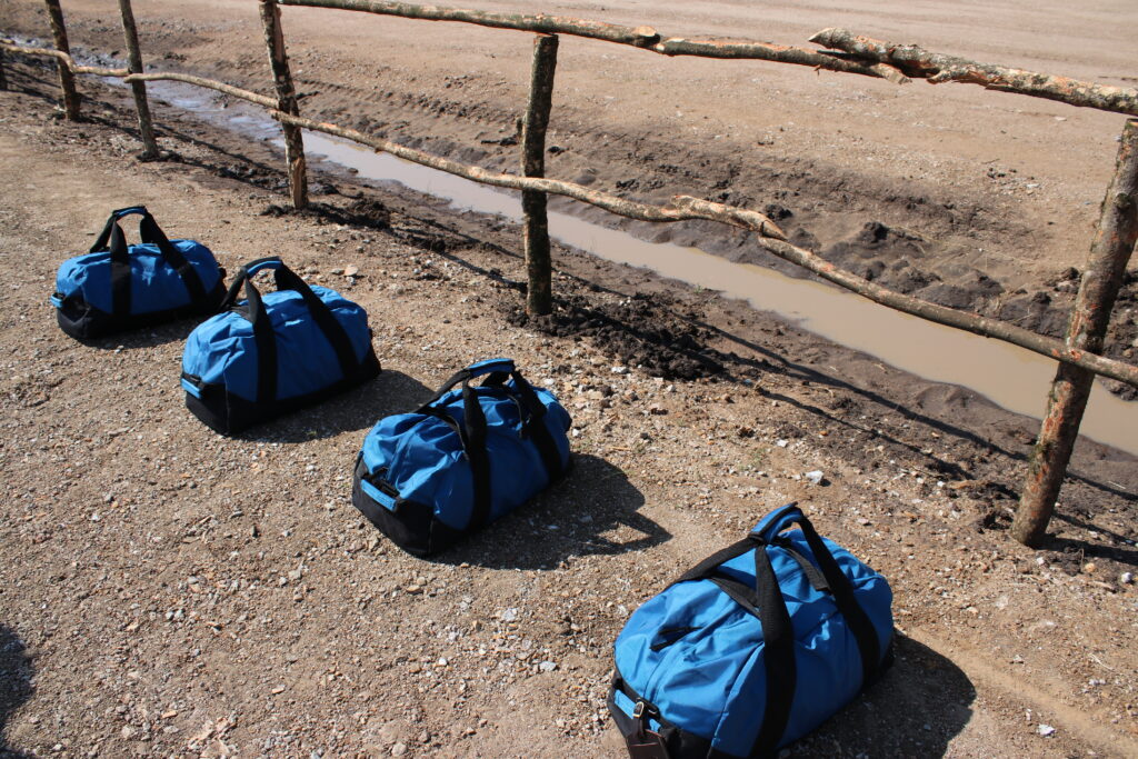 LL Bean duffel bags Africa Kenya dirt runway